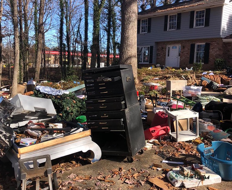 close-up of junk in front yard of house