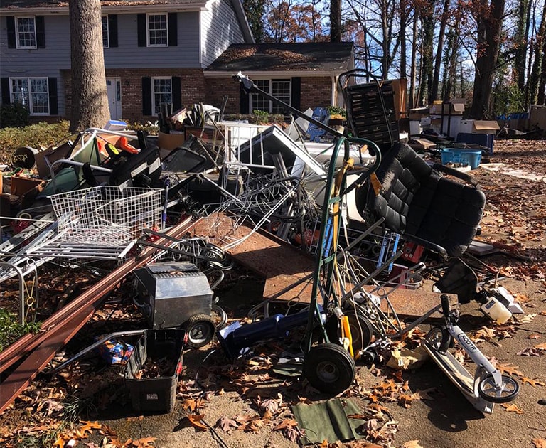 close-up of pile of junk in front of house door