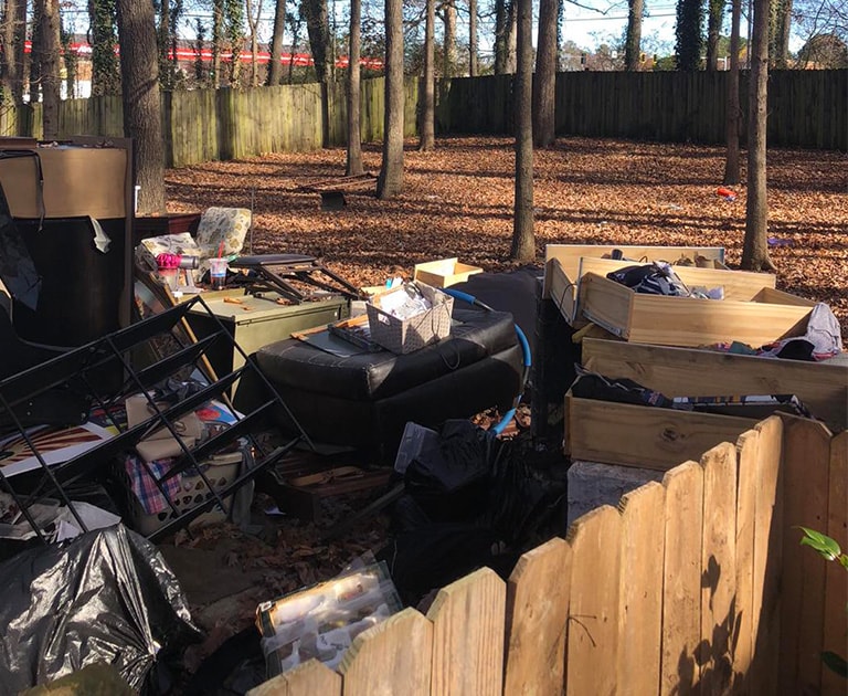 pile of junk on back patio of house