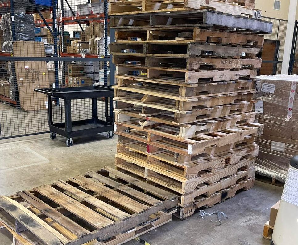 multiple pallets stacked inside of warehouse