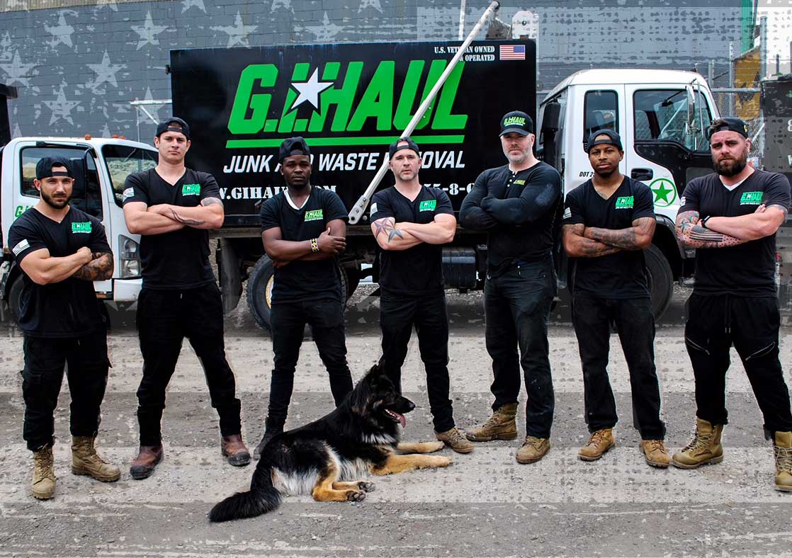 g.i. haul employees with dog smiling for portrait