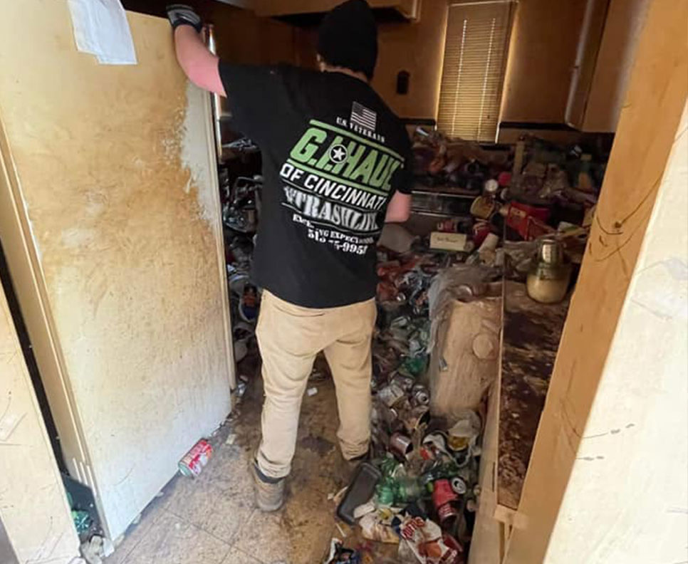 employee cleaning out hoarder apartment