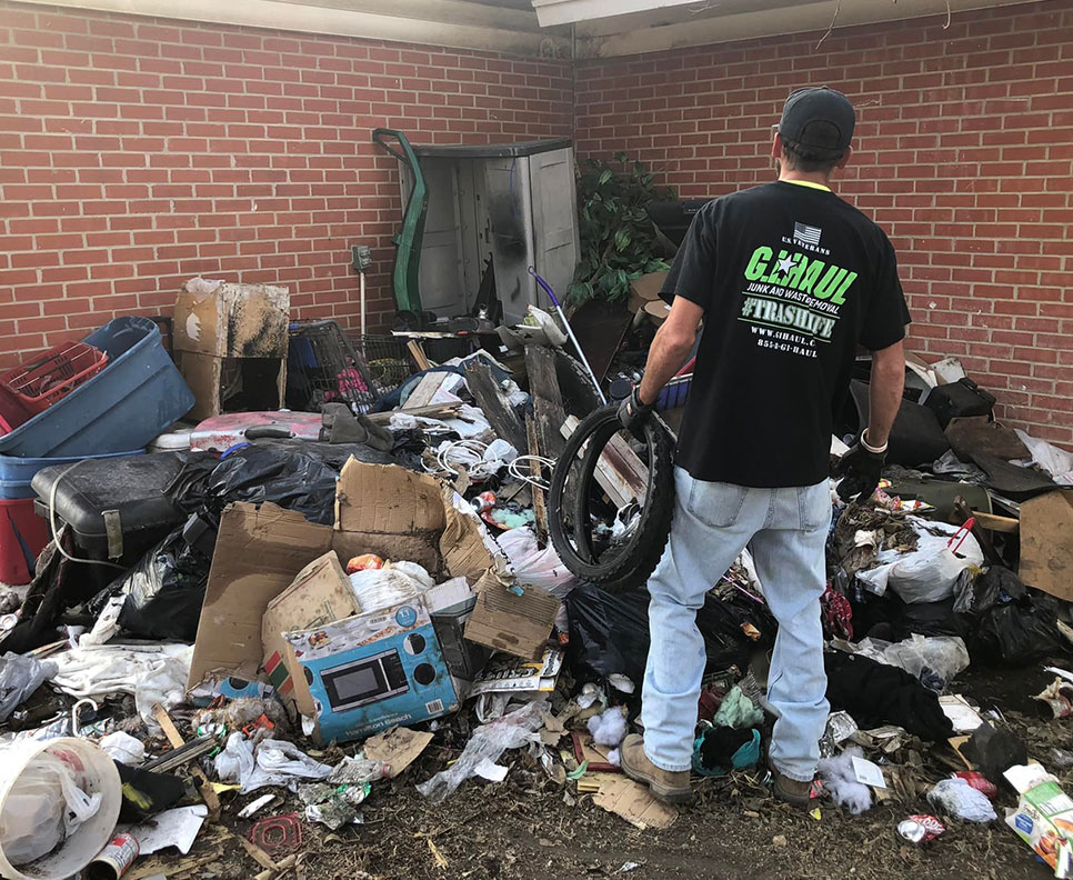 trash piled high in home's back yard