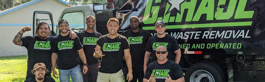 gihaul employees posing in front of truck